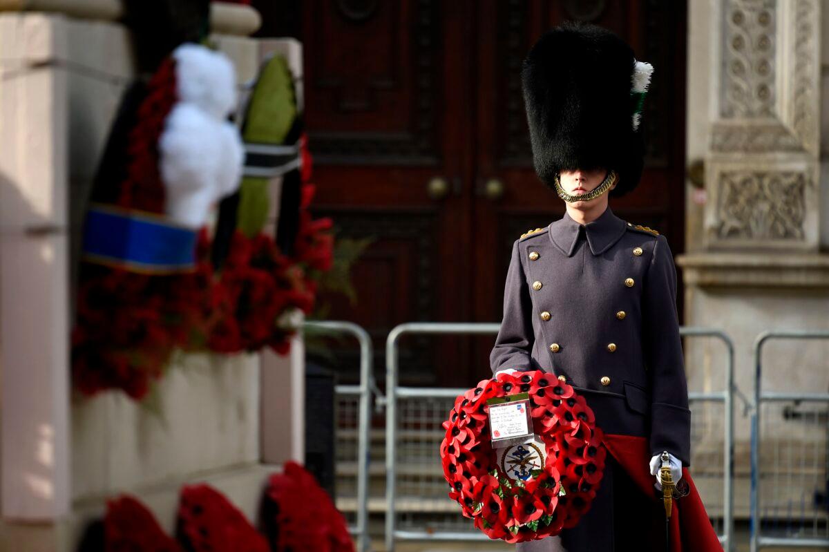A member of the Queen's Guard holds a wreath as he prepares to observe a 2-minute silence for Armistice Day in remembrance of the nation's war dead on Nov. 11, 2020, in London. (Daniel Leal-Olivas/AFP)