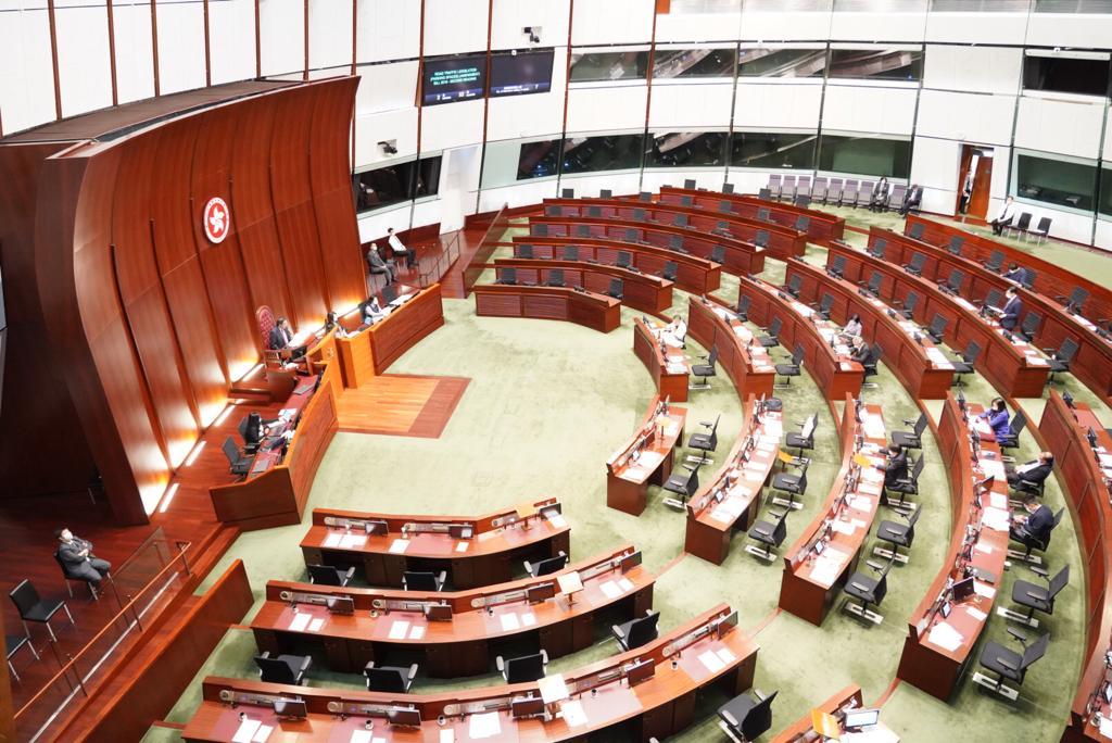 Hong Kong’s Legislative Council convenes for a session with many empty seats (top) that are supposed to be occupied by pro-democracy lawmakers in Hong Kong on Nov. 12, 2020. (Yu Gang/The Epoch Times)