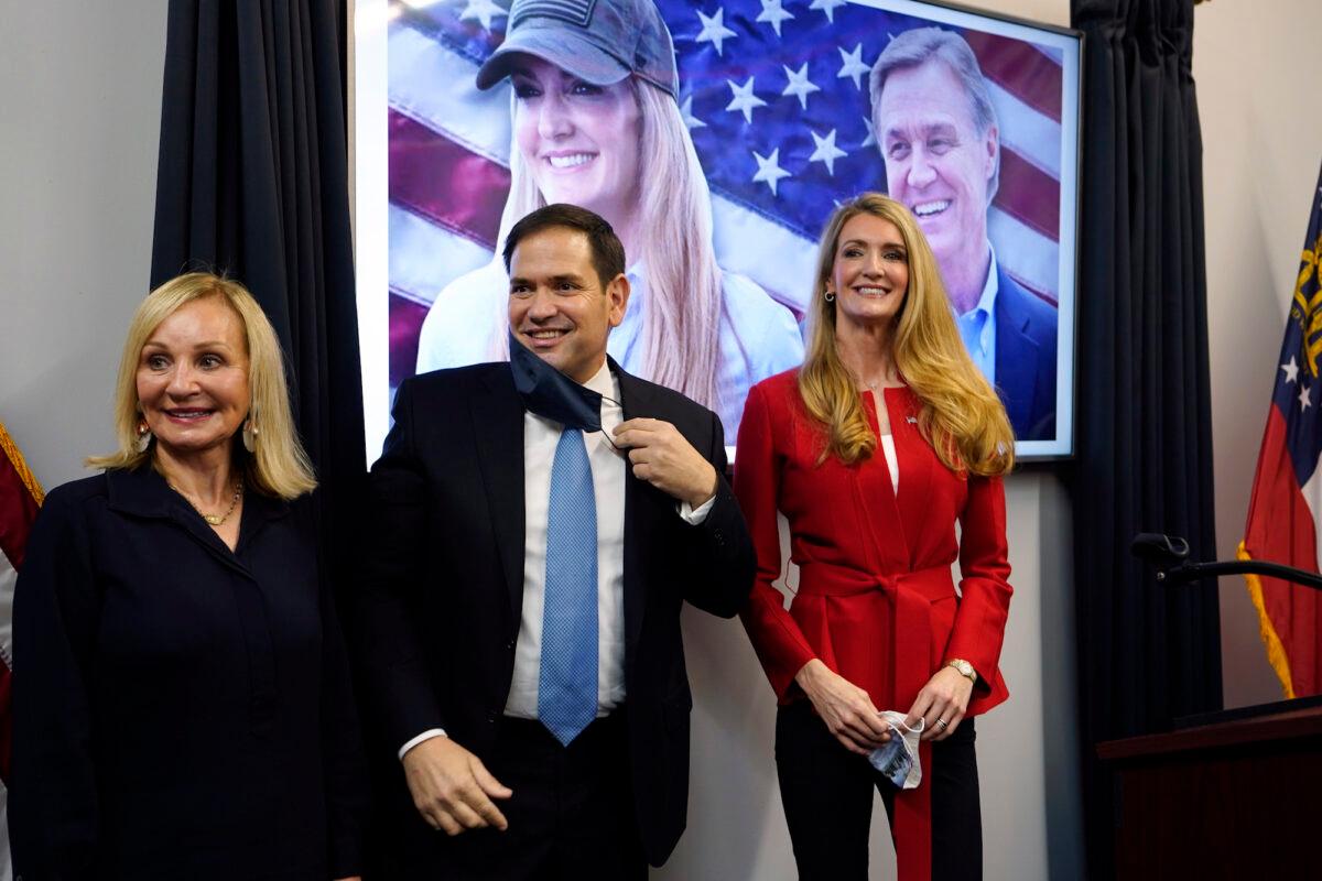 Sen. Marco Rubio (R-Fla.) stands with Sen. Kelly Loeffler (R-Ga.) (R) and Bonnie Perdue, wife of Sen. David Perdue (R-Ga.), after a campaign rally in Marietta, Ga., on Nov. 11, 2020. (John Bazemore/AP Photo)
