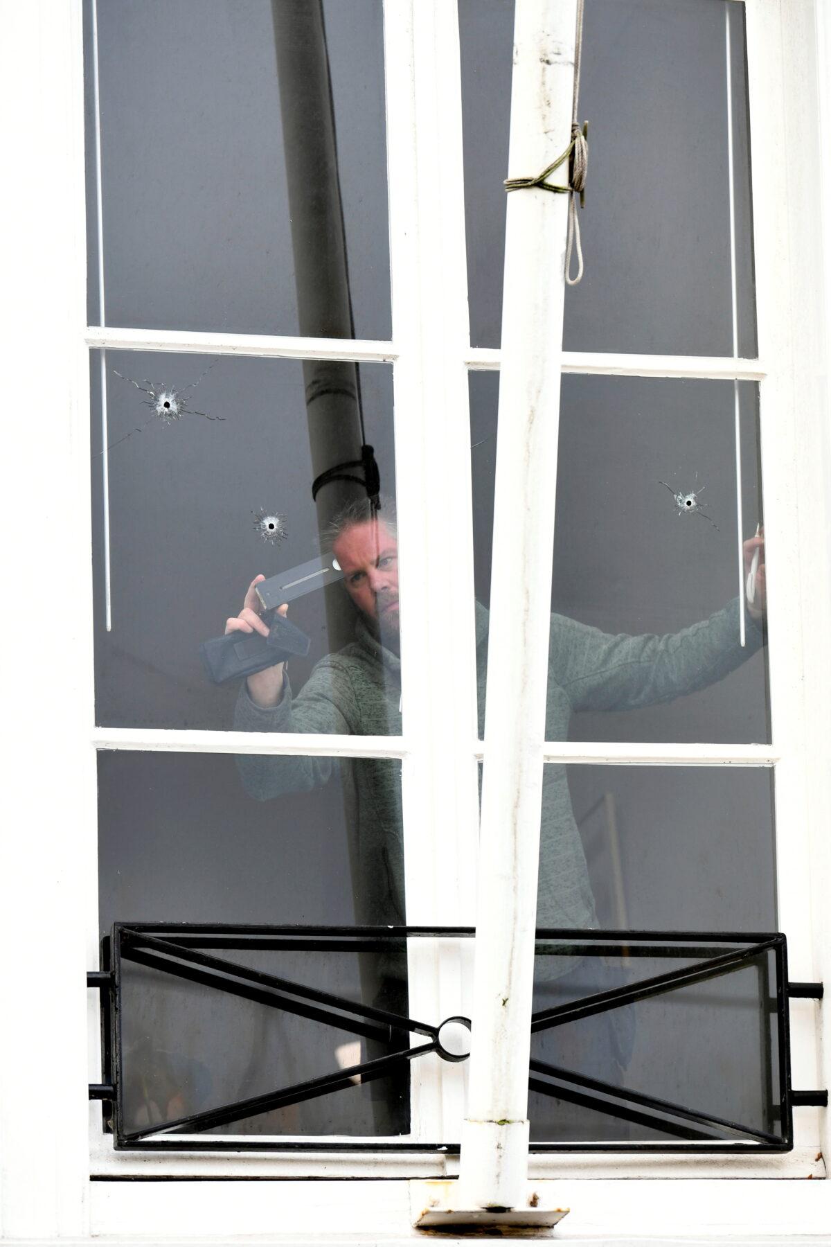 Bullet holes in the window of the Embassy of Saudi Arabia are pictured after unidentified assailants sprayed it with gunfire, in The Hague, Netherlands Nov. 12, 2020. (Piroschka van de Wouw/Reuters)