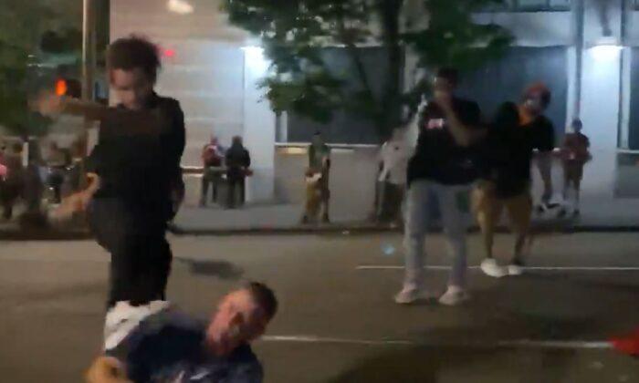 A man identified by police as Marquise Love (L) kicks Adam Haner in the face in Portland, Ore., on Aug. 16, 2020. (Kalen D’Almeida/Scriberr News)