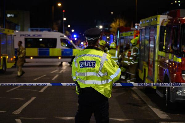 Police officers secure the cordon around Edmonton Green police station, following an incident involving a car colliding with the front doors of the building in the Edmonton area of London on Nov. 11, 2020. (Leon Neal/Getty Images)