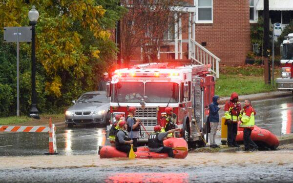 Charlotte Fire water rescue stand at the ready on West Blvd. during a heavy rain in Charlotte, N.C., on Nov. 12, 2020. (Jeff Siner/The Charlotte Observer via AP)
