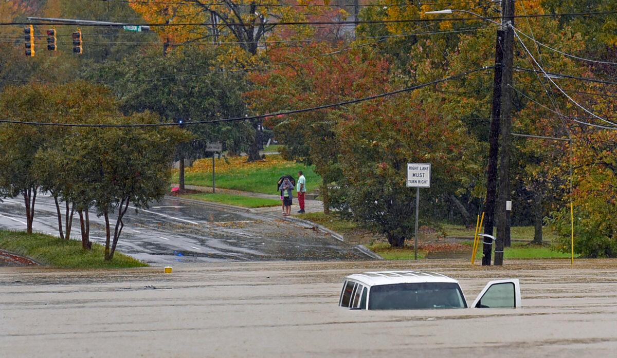 A vehicle is submerged in floodwater on Freedom Drive in Charlotte, N.C., on Nov. 12, 2020. (Jeff Siner/The Charlotte Observer via AP)