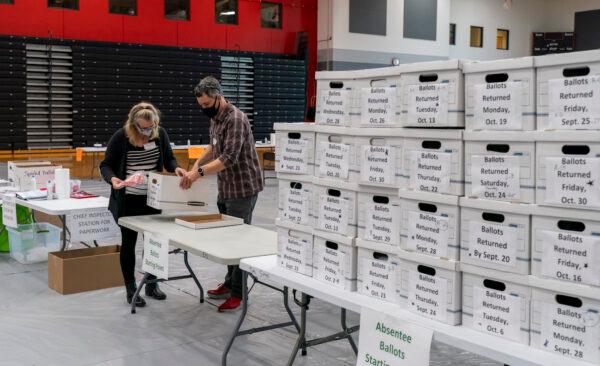 Poll workers check in a box of absentee ballots at Sun Prairie High School in Sun Prairie, Wis., on Nov. 3, 2020. (Andy Manis/Getty Images)