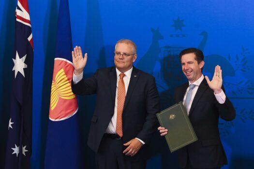 Australian Trade Minister Simon Birmingham (right) and Australian Prime Minister Scott Morrison react after signing the Regional Comprehensive Economic Partnership (RCEP) during a virtual signing ceremony at Parliament House in Canberra, Australia, on Nov. 15, 2020. (AAP Image/Lukas Coch)