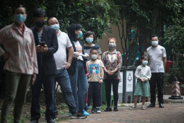 Residents wearing masks wait in line for nucleic acid testing at a residential community in Wuhan, the capital of China's Hubei Province, on May 15, 2020. (Getty Images)
