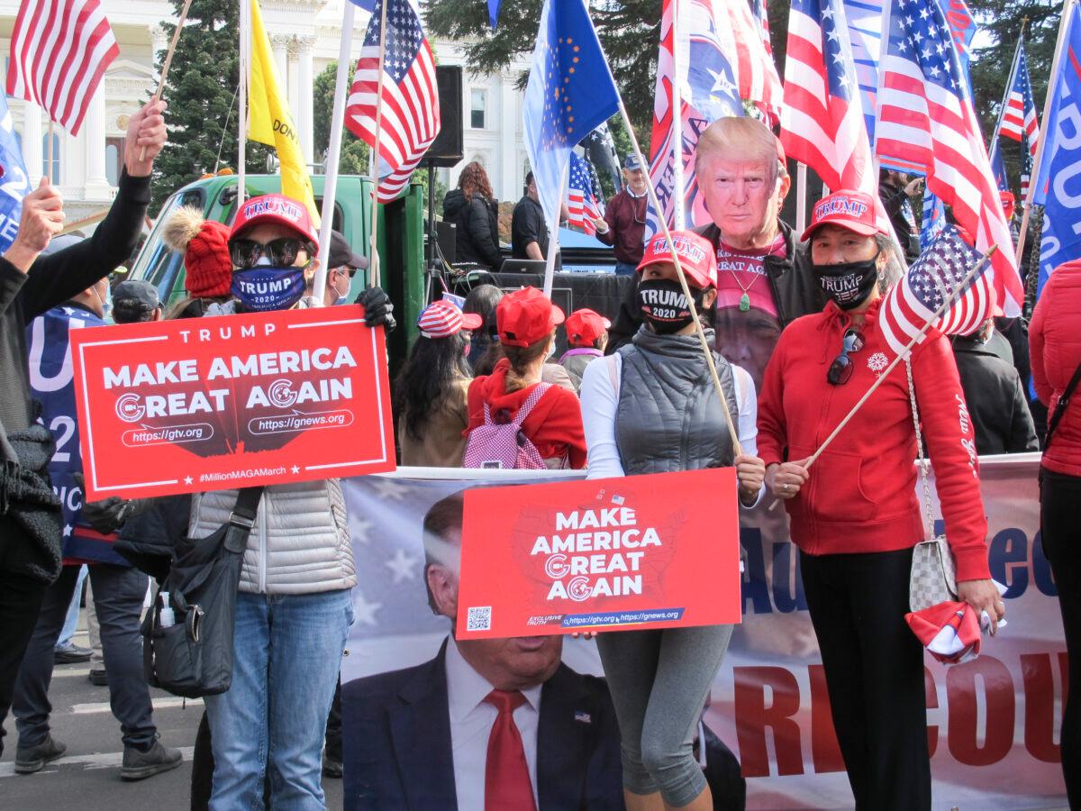 Rally attendees hold MAGA signs with a person wearing a printout of President Trump's face in Sacramento, Calif., on Nov. 14, 2020. (Ilene Eng/The Epoch Times)