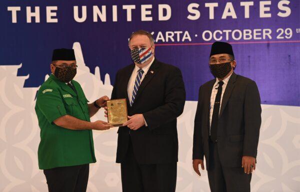 U.S. Secretary of State Mike Pompeo receives a placard from Yakut Qoumas (L), General Chairman of Gerakan Pemuda Ansor next to Yahya Cholil Staquf (R), General Secretary of Nahdlatul Ulama at the Nahdlatul Ulama in Jakarta, Indonesia on Oct. 29, 2020. (ADEK BERRY/POOL/AFP via Getty Images)