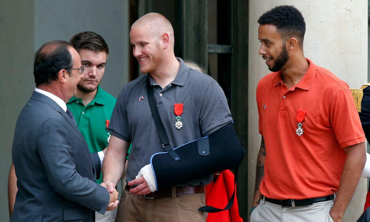  French President Francois Hollande bids farewell to U.S. Airman Spencer Stone, U.S. National Guardsman Alek Skarlatos (second from left), and Anthony Sadler (R), a senior at Sacramento State University in California, after Hollande awarded them the French Legion of Honor at the Elysee Palace, in Paris, on Aug. 24, 2015. (Michel Euler/AP Photo)