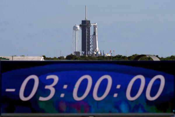 The countdown clock is stopped at a three-hour built in hold as a SpaceX Falcon 9 rocket, with the company's Crew Dragon capsule attached, sits on the launch pad at Launch Complex 39A, at the Kennedy Space Center in Cape Canaveral, Fla., on Nov. 15, 2020. (Chris O'Meara/AP Photo)