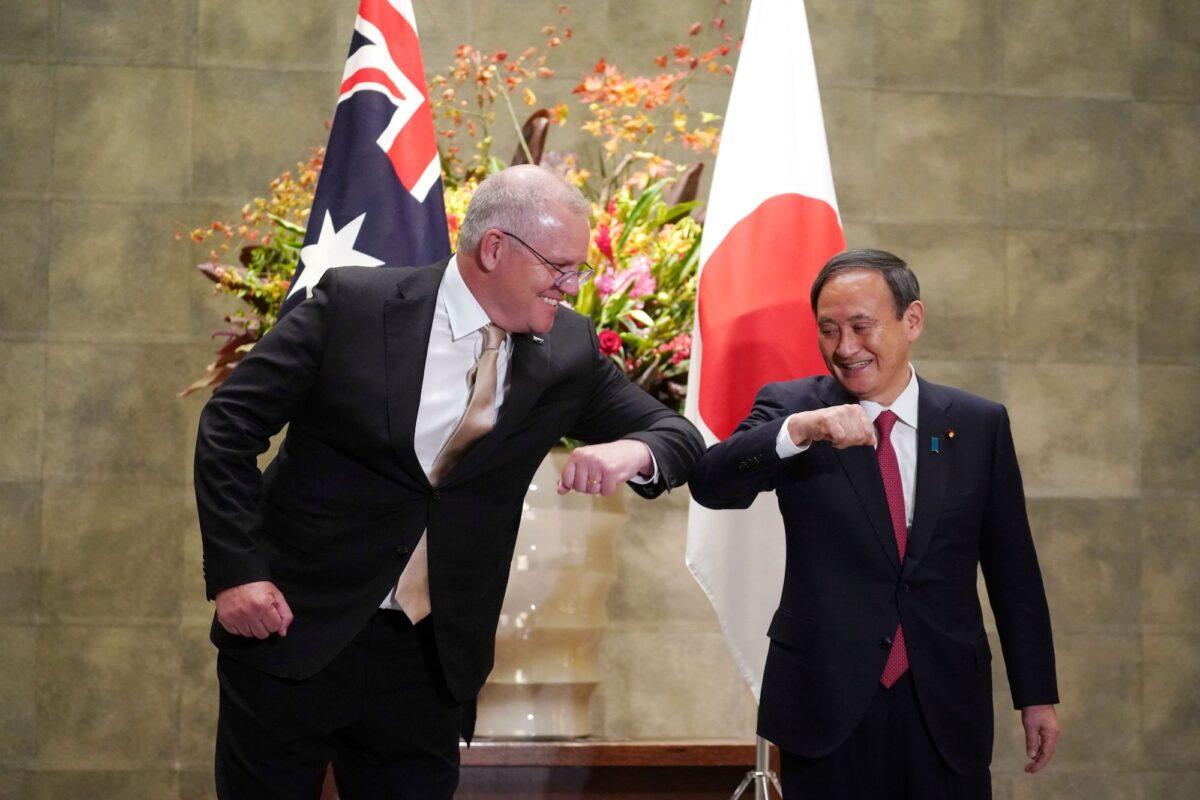 Australia's Prime Minister Scott Morrison (L) is greeted by Japan's Prime Minister Yoshihide Suga (R) prior to an official welcoming ceremony at Suga's official residence in Tokyo on Nov. 17, 2020. (Eugene Hoshiko / POOL / AFP)