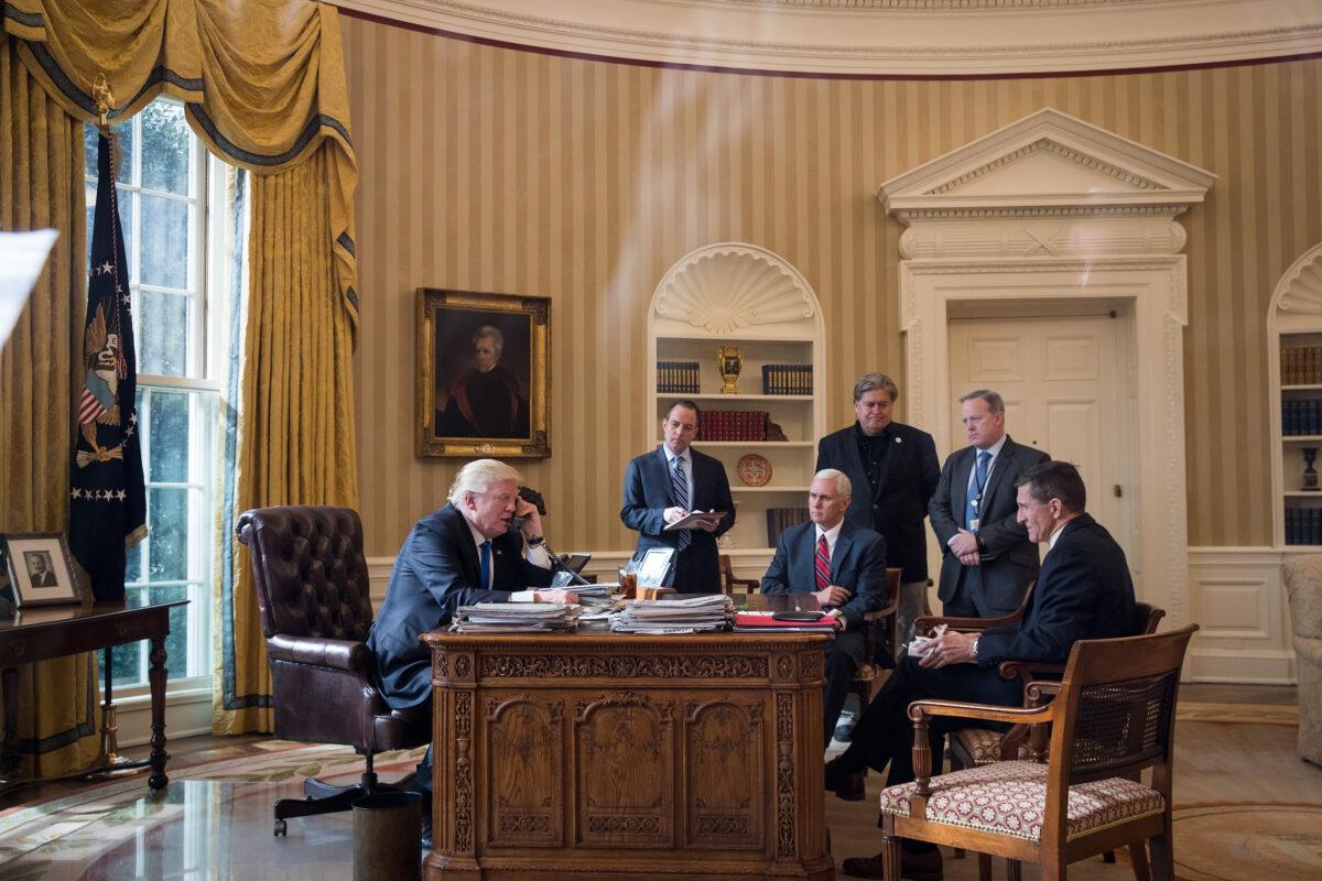President Donald Trump speaks on the phone with Russian President Vladimir Putin in the Oval Office of the White House on Jan. 28, 2017. (Drew Angerer/Getty Images)