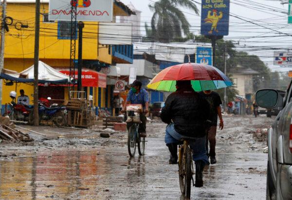 Locals move on street barely cleared from the debris of the last storm, before Hurricane Iota makes landfall in La Lima, Honduras on Nov. 16, 2020. (Delmer Martinez/AP Photo)