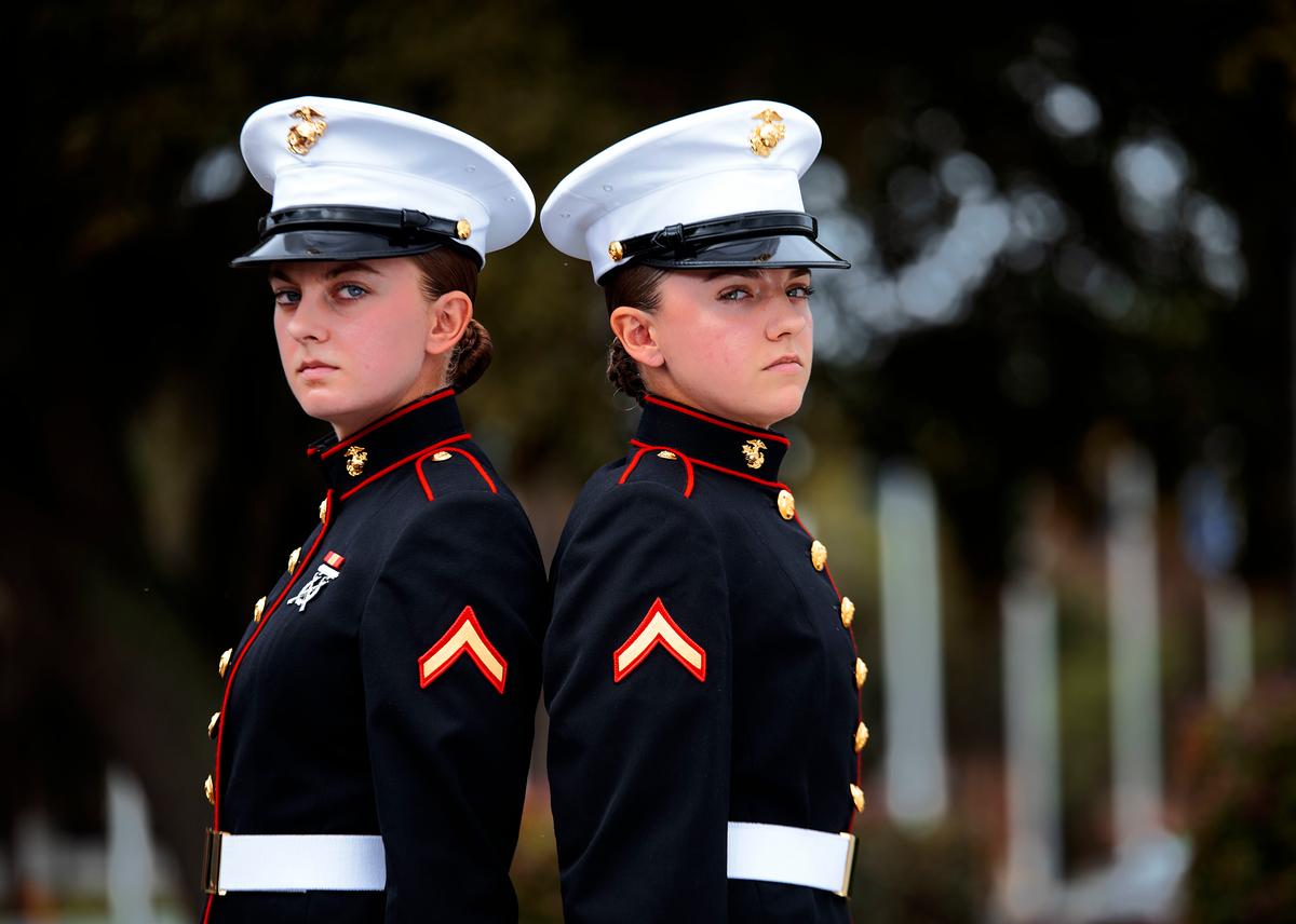 Sisters Amber and Ashley Valentine pose on the Peatross Parade Deck at MCRD Parris Island on Nov. 13, 2020. (<a href="https://www.dvidshub.net/image/6424166/sisters-blood-now-sisters-arms-two-sets-sisters-graduate-recruit-training">Sgt. Dana Beesley</a>/U.S. Marine Corps)