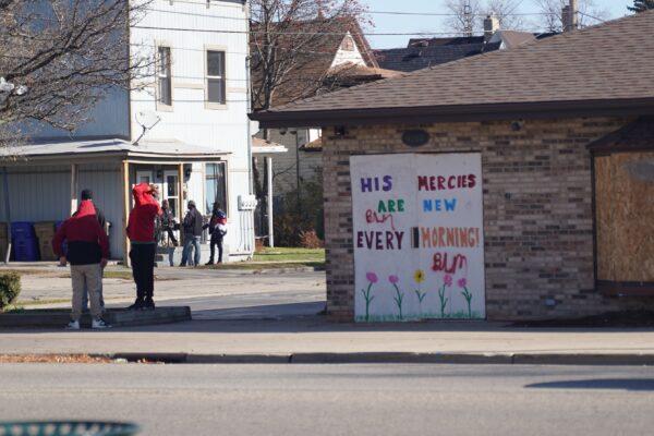 Boarded up shops are decorated with hopeful messages, along with graffiti for Black Lives Matter (BLM), in Kenosha, Wis., on Nov. 12, 2020. (Cara Ding/The Epoch Times)