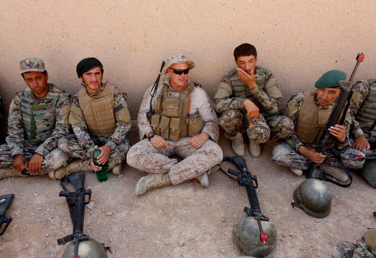 A U.S. Marine, center, talks with Afghan National Army soldiers during a training in Helmand province, Afghanistan, on July 5, 2017. (Omar Sobhani/Reuters)