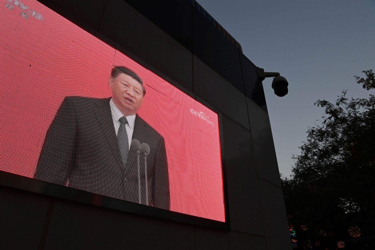 A video clip of Chinese leader Xi Jinping is seen on the outside of a police patrol station in Beijing on Nov. 2, 2020. (Greg Baker/AFP via Getty Images)