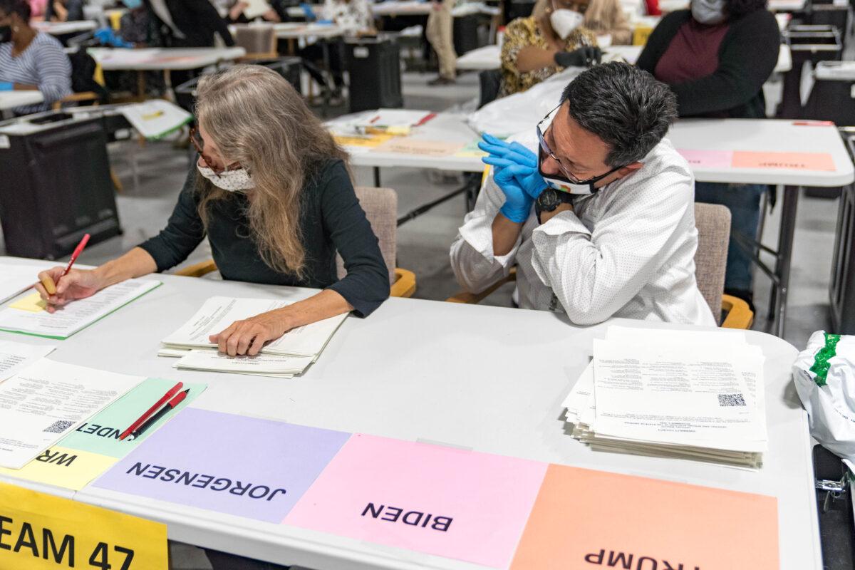 Gwinnett County election workers handle ballots as part of the recount for the 2020 presidential election at the Beauty P. Baldwin Voter Registrations and Elections Building in Lawrenceville, Ga., on Nov. 16, 2020. (Megan Varner/Getty Images)