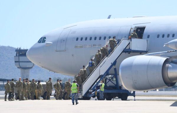Australian troops from 3 RAR (Royal Australian Regiment) are seen boarding a KC 30 aircraft which will take them to Victoria on Sept. 11, 2020, in Townsville, Australia. (Ian Hitchcock/Getty Images)