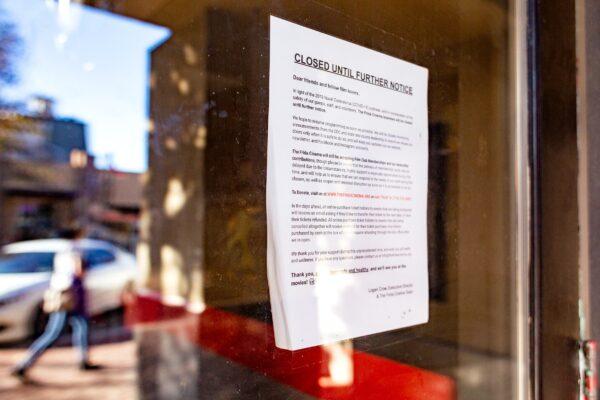 A notice of closure due to COVID-19 is posted on the door to the Frida Cinema in Santa Ana, Calif., on Nov. 17, 2020. (John Fredricks/The Epoch Times)