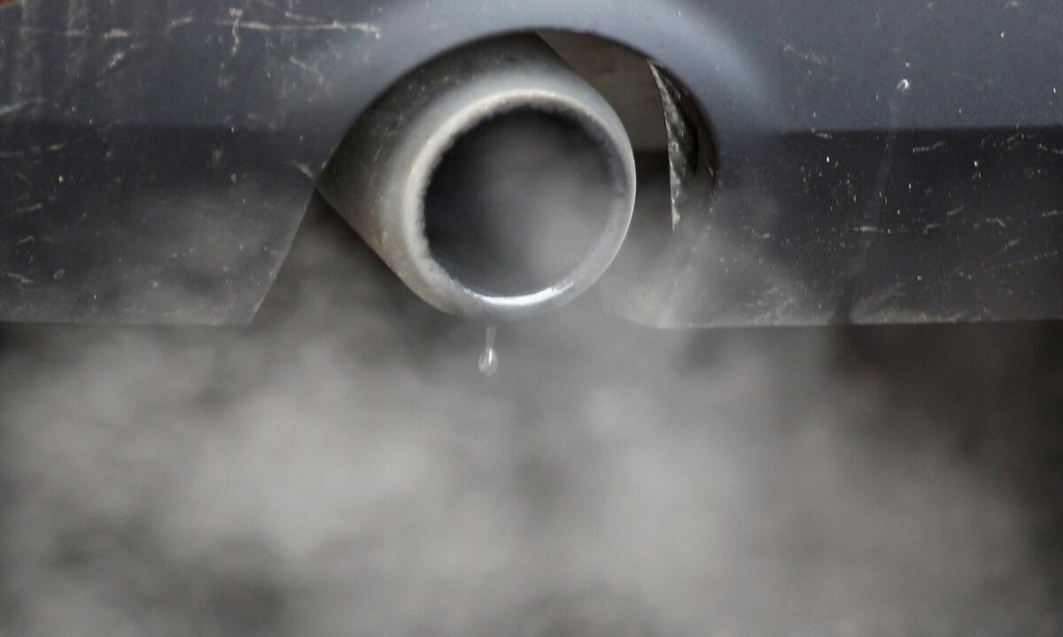An exhaust emits fumes as a car is driven through Richmond in London on Dec. 2, 2016. (Peter Nicholls/Reuters)