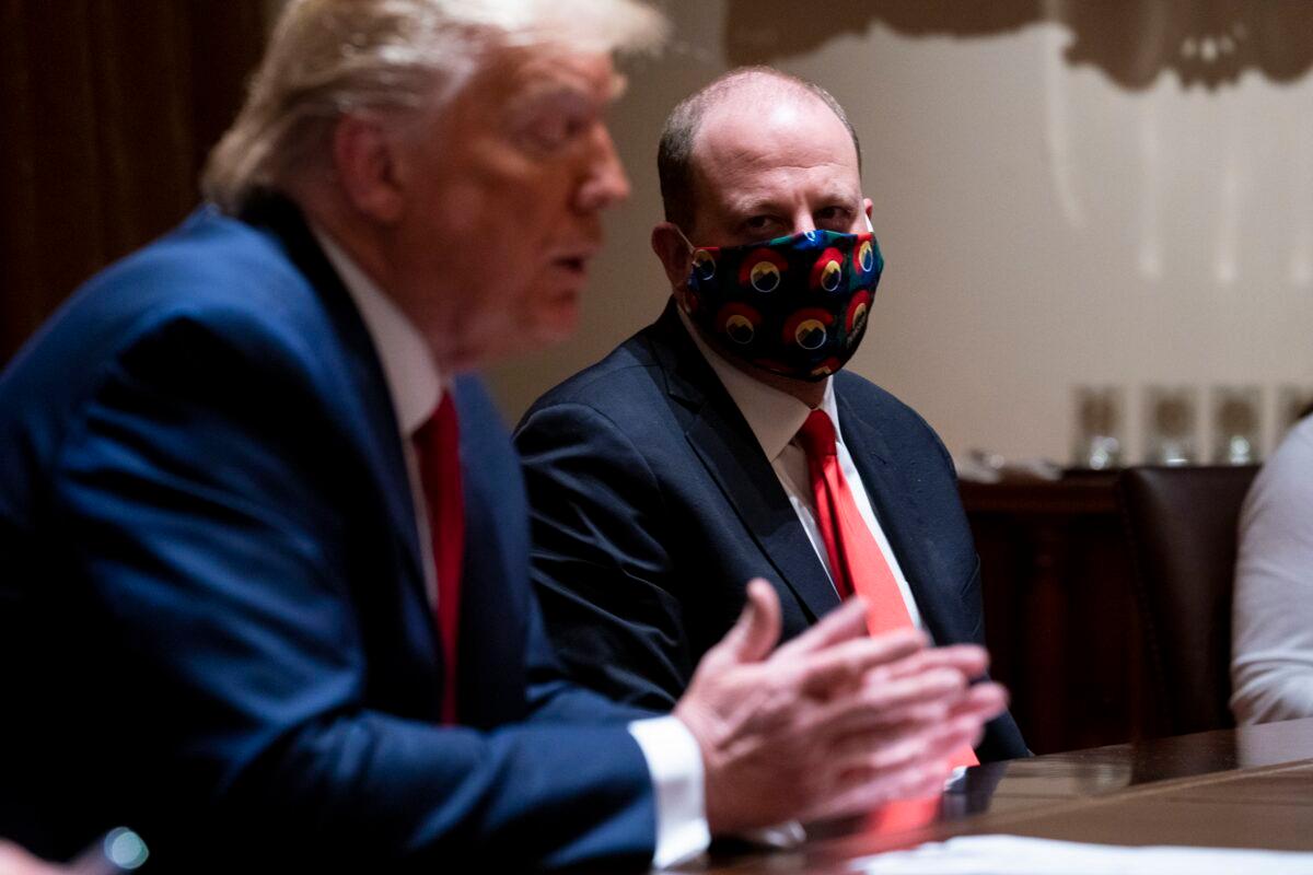 Colorado Gov. Jared Polis, right, meets with President Donald Trump at the White House in Washington on May 13, 2020. (Doug Mills/Pool/Getty Images)