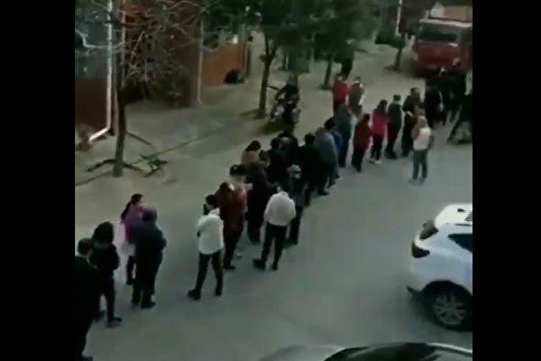 Screenshot of a video clip showing people lining up for COVID-19 testing at a checkpoint in Yanliang district, Xi'an city, Shaanxi Province, on Nov. 15. (Provided by The Epoch Times)