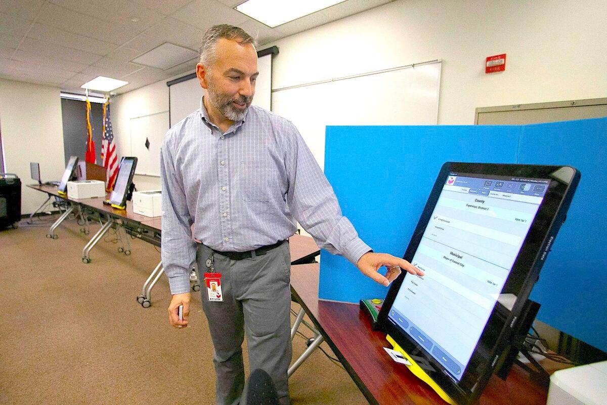A Dominion Voting Systems employee demonstrates a voting machine in Atlanta, Ga., on Nov. 13, 2019. (John Bazemore/AP Photo)
