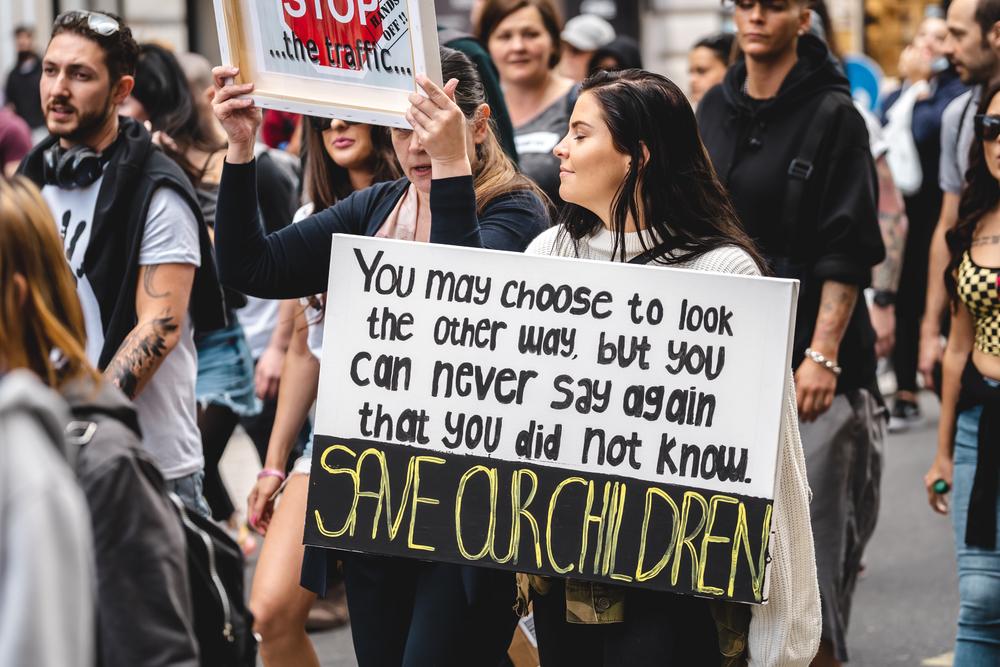 Demonstrators with placards shout at a Save Our Children Protest against the trafficking of children. (Sandor Szmutko/Shutterstock)