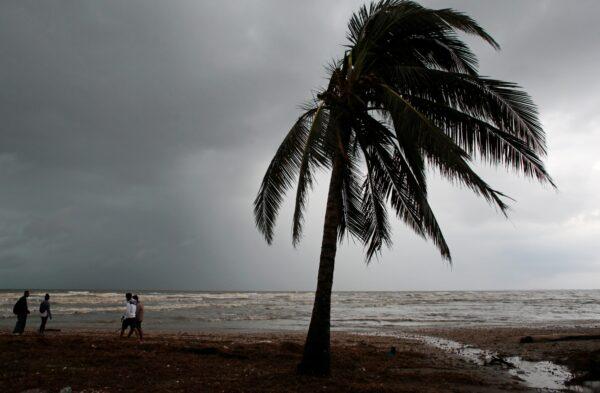 Residents walk along a beach after the passing of Hurricane Iota, in Puerto Cabezas, Nicaragua, on Nov. 17, 2020. (Oswaldo Rivas/Reuters)
