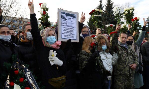 People gather outside a church during a memorial service for Roman Bondarenko, an anti-government protester who died in hospital following what witnesses said was a severe beating by security forces, in Minsk, on Nov. 20, 2020. (Stringer/Reuters)