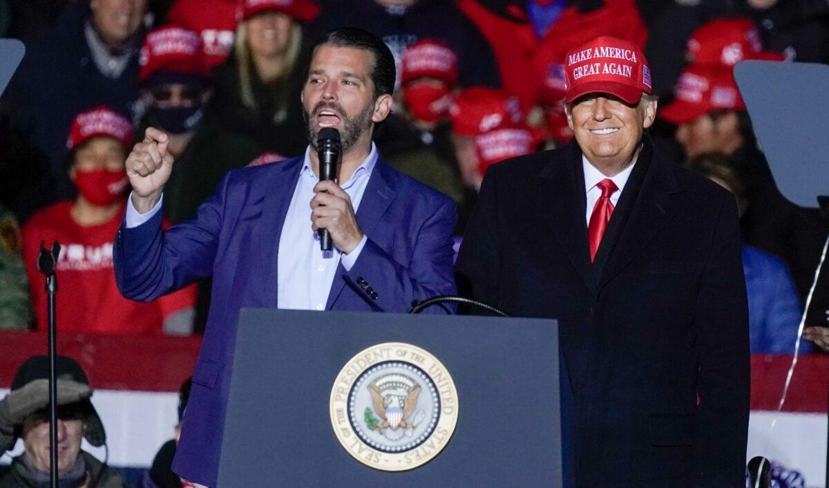 Then-President Donald Trump watches as Donald Trump Jr. speaks at a campaign event at the Kenosha Regional Airport in Kenosha, Wis., on Nov. 2, 2020. (Morry Gash/AP)