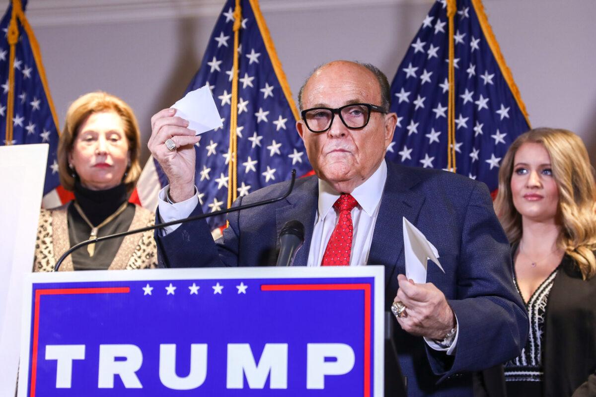 Trump lawyer and former New York City Mayor Rudy Giuliani speaks to media while flanked by Trump campaign lawyer Sidney Powell (L) and Trump campaign senior legal adviser Jenna Ellis at a press conference at the Republican National Committee headquarters in Washington on Nov. 19, 2020. (Charlotte Cuthbertson/The Epoch Times)