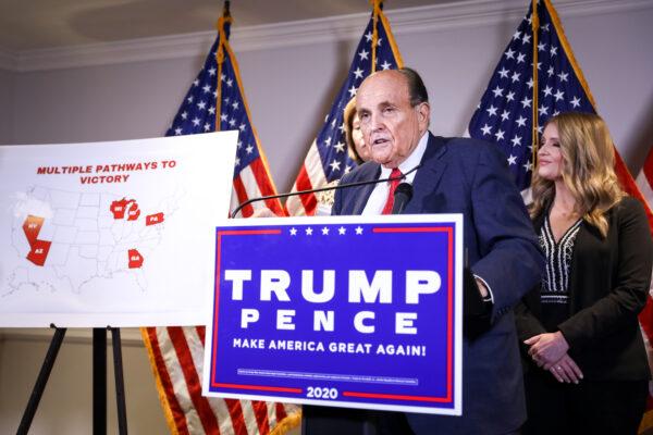 Trump lawyer and former New York City Mayor Rudy Giuliani speaks to media while flanked by Trump campaign lawyer Sidney Powell (L) and Trump campaign senior legal adviser Jenna Ellis at a press conference at the Republican National Committee headquarters in Washington on Nov 19, 2020. (Charlotte Cuthbertson/The Epoch Times)