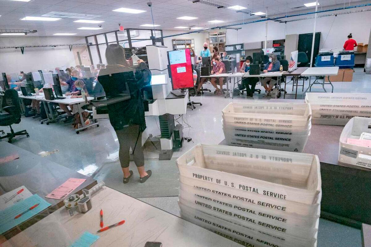 Poll workers count ballots inside the Maricopa County Election Department in Phoenix, Ariz., on Nov. 5, 2020. (Olivier Touron/AFP via Getty Images)