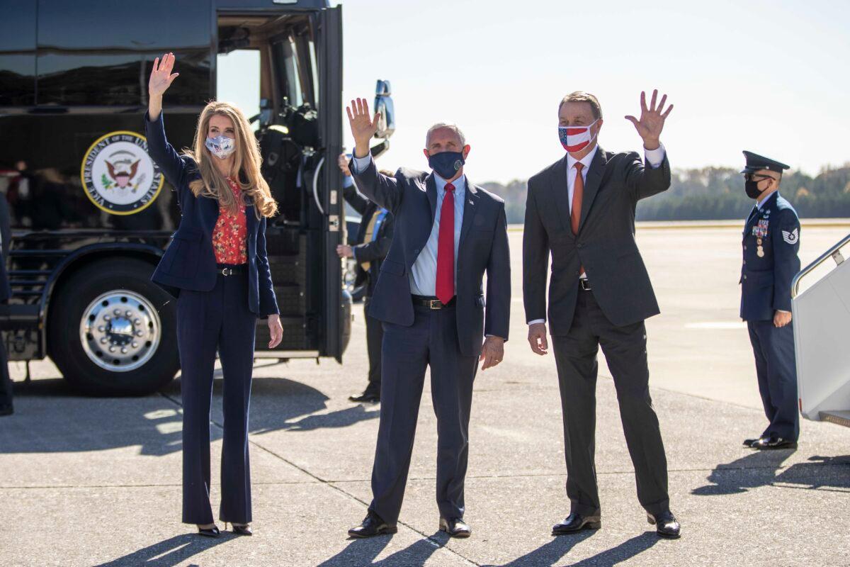 Vice President Mike Pence, center, Sen. Kelly Loeffler (R-Ga.), left, and Sen David Perdue (R-Ga.), in Marietta, Ga., on Nov. 20, 2020. (Alyssa Pointer/Atlanta Journal-Constitution via AP)