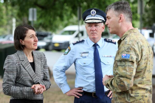 Premier Gladys Berejiklian speaks with NSW Police Commissioner Mick Fuller and Brigadier Mick Garraway at the Victorian border checkpoint in South Albury in Albury, Australia on Nov. 22, 2020. (Lisa Maree Williams/Getty Images)