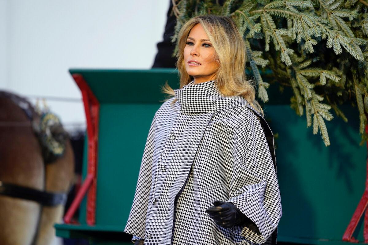 First Lady Melania Trump stands next to the 2020 Official White House Christmas tree as it is presented on the North Portico of the White House in Washington on Nov. 23, 2020. (Andrew Harnik/AP Photo)