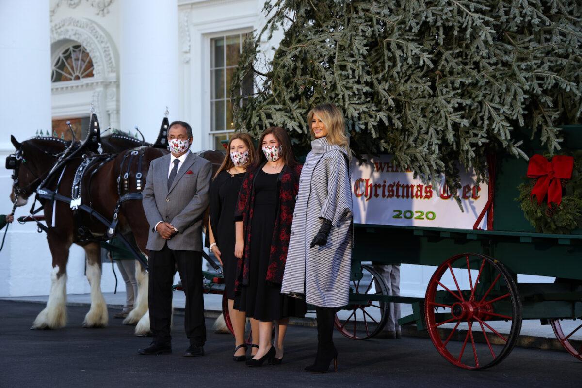 First Lady Melania Trump poses for photos with tree farm owner Dan Taylor and his family in front of the 2020 White House Christmas Tree at the White House in Washington on Nov. 23, 2020. (Alex Wong/Getty Images)