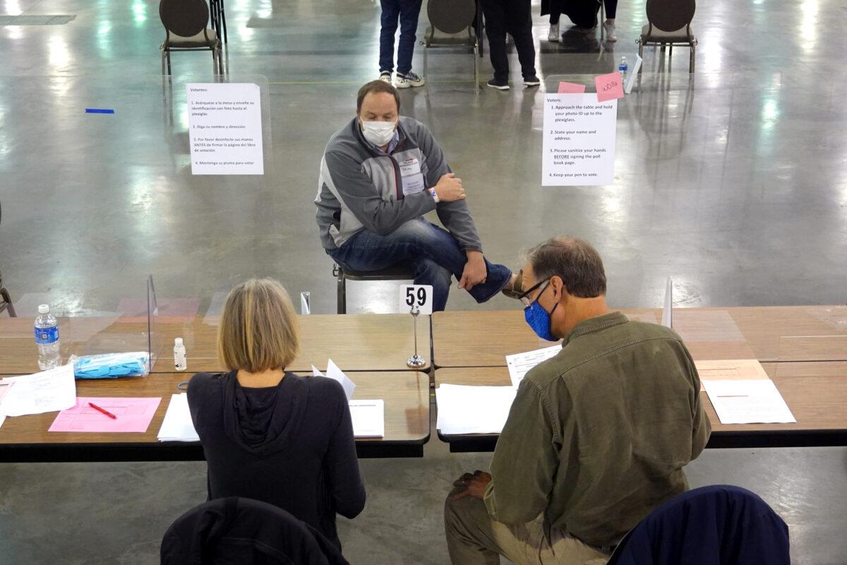 An observer watches as election officials begin the recount process of ballots from the November 3 election at the Wisconsin Center in Milwaukee, Wis., on Nov. 20, 2020. (Scott Olson/Getty Images)