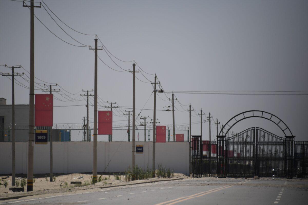 Chinese flags on a road leading to a facility believed to be a reeducation camp where mostly Muslim ethnic minorities are detained, on the outskirts of Hotan in China's northwestern Xinjiang region, on May 31, 2019. (Greg Baker/AFP via Getty Images)