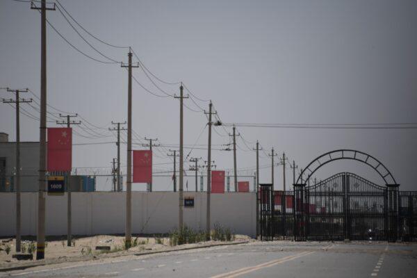 Chinese flags on a road leading to a facility believed to be a reeducation camp where mostly Muslim ethnic minorities are detained, on the outskirts of Hotan in the Xinjiang region of China, on May 31, 2019. (Greg Baker/AFP via Getty Images)