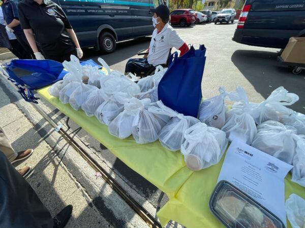 Bags of prepared Thanksgiving meals line a table at the El Modena Family Resource Center in Orange, Calif., on Nov. 23, 2020. (Drew Van Voorhis/The Epoch Times)