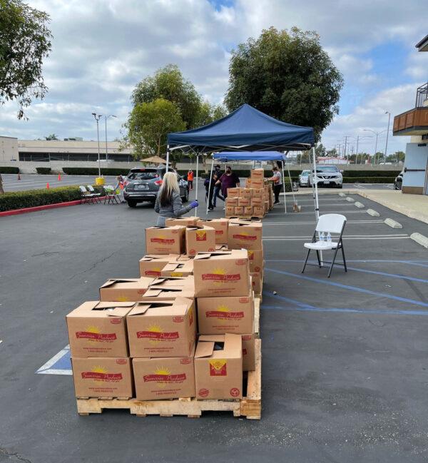Boxes filled with food supplies wait on pallets outside the First Assembly Church in Santa Ana, Calif., on Nov. 23, 2020. (Drew Van Voorhis/The Epoch Times)