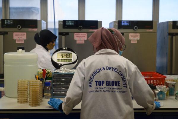 Staff work at the Top Glove factory research and development lab in Shah Alam on the outskirts of Kuala Lumpur on Aug. 26, 2020. (Mohd Rasfan/AFP via Getty Images)