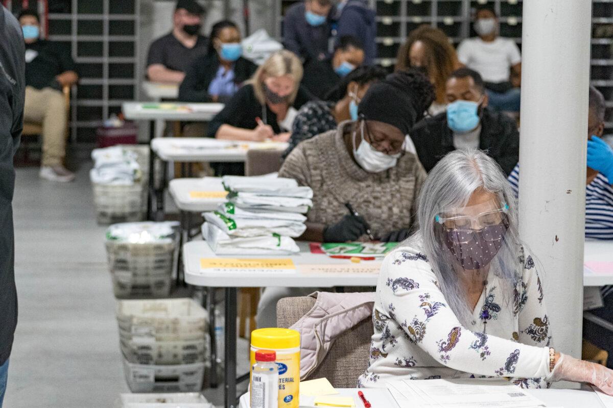 Gwinnett County election workers handle ballots as part of the recount for the 2020 presidential election at the Beauty P. Baldwin Voter Registrations and Elections Building in Lawrenceville, Ga. on Nov. 16, 2020. (Megan Varner/Getty Images)