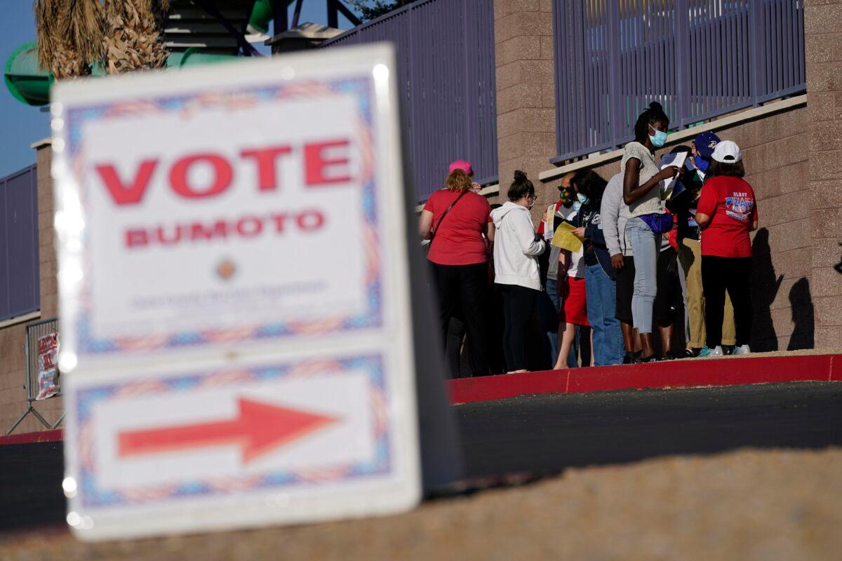 People wait in line to vote at a polling place on Election Day in Las Vegas, Nev., on Nov. 3, 2020. (John Locher/AP Photo)