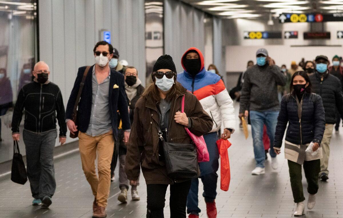 Travelers wear masks while walking through the World Trade Center's transportation hub in New York on Nov. 17, 2020. (Mark Lennihan/AP Photo)