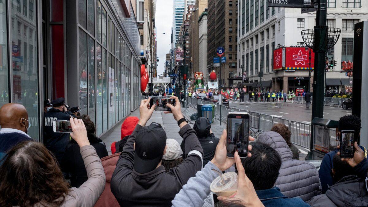People attempt to take photos as the last floats that are part of the modified Macy's Thanksgiving Day Parade move away in New York City, on Nov. 26, 2020. (Craig Ruttle/AP Photo)